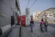 People walk past a closed bank in downtown Goma, Democratic 