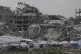 A tent camp for displaced Palestinians is set up amid destro