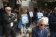 Protesters hold photos of detainees during a gathering outsi
