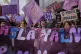 Women chat during a protest marking International Women's Da