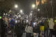 People use the lights on their cell phones as they observe f