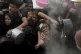 A Palestinian girl struggles as she and others try to get do