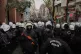 Police officers block a street as university students march 