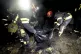 Rescue workers collect the body parts of a person killed in 