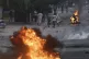 Demonstrators run after police officers fired tear gas durin