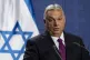 Viktor Orban stands in front of the Israeli flag while welco