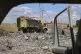 Debris is scattered at the site of an Israeli strike on a mi