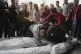 Palestinians mourn over the bodies of their relatives who we