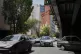 Vehicles drive in front of an anti-U.S. mural in downtown Te