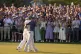 Rory McIlroy, of Northern Ireland, is embraced by caddie Har