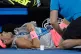 Rafael Nadal receives treatment from a trainer during his qu
