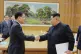 North Korean leader Kim Jong Un (right) shakes hands yesterd