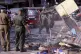Sri Lankan soldiers clear debris of a vandalised building in