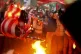 People burn the US flag in protest of President Donald Trump