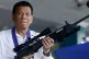 Philippine President Rodrigo Duterte holds an Israeli-made G