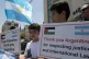 Palestinian boys hold banners in front of Argentinian repres