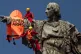 Two activists climb on top of the 197-feet monument Christop