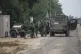 Israeli soldiers stand near the southern Israel Gaza border