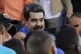 Venezuela's President Nicolas Maduro surrounded by students 