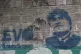 A stencil of former President Evo Morales adorns a a wall in