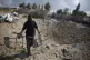 A masked Palestinian man checks the damage following overnig
