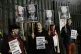 Supporters of Julian Assange hold placards as they protest o