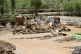 Afghan men collect their belongings from their damaged home 