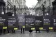 Demonstrators from Amnesty International, dressed in black a