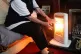 An elderly lady with her electric fire on at home in Liverpo