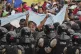 A soccer fan joins retirees protesting for higher pensions a