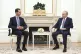 Syrian President Bashar Assad (left) speaks with Russian Pre
