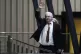 WikiLeaks founder Julian Assange waves after landing at RAAF