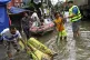Volunteers use a boat to help rescue people on a flooded str