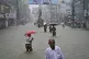 People navigate a flooded street following incessant rains i