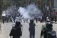 Students clash with riot police during a protest against a q