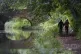People walk along the Basingstoke Canal near to Dogmersfield
