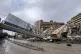 A pedestrian bridge collapsed next of a destroyed building t