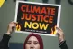 A demonstrator holds a sign that reads 