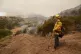 A firefighter keeps watch on advancing flames from the Lake 