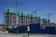 A construction worker walks past a housing project under con