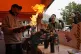 A vendor makes flaming marshmallow ice cream at a food stall