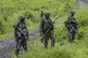M23 rebels stand with their weapons in Kibumba, in the easte