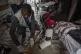 Medics treat a man who was wounded during fighting between C