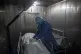 A healthcare worker fills out paper work for a patient who d