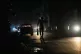 A resident walks on a street during a general blackout in Ha