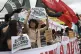 People hold signs against former Philippine President Rodrig