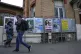 People walk past a row of campaign posters for the upcoming 