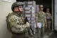 Navy soldiers stand guard over boxes of election materials t