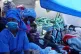 Women and children on board the Open Arms rescue ship wait t