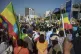 Ethiopians holding national flags protest against what they 